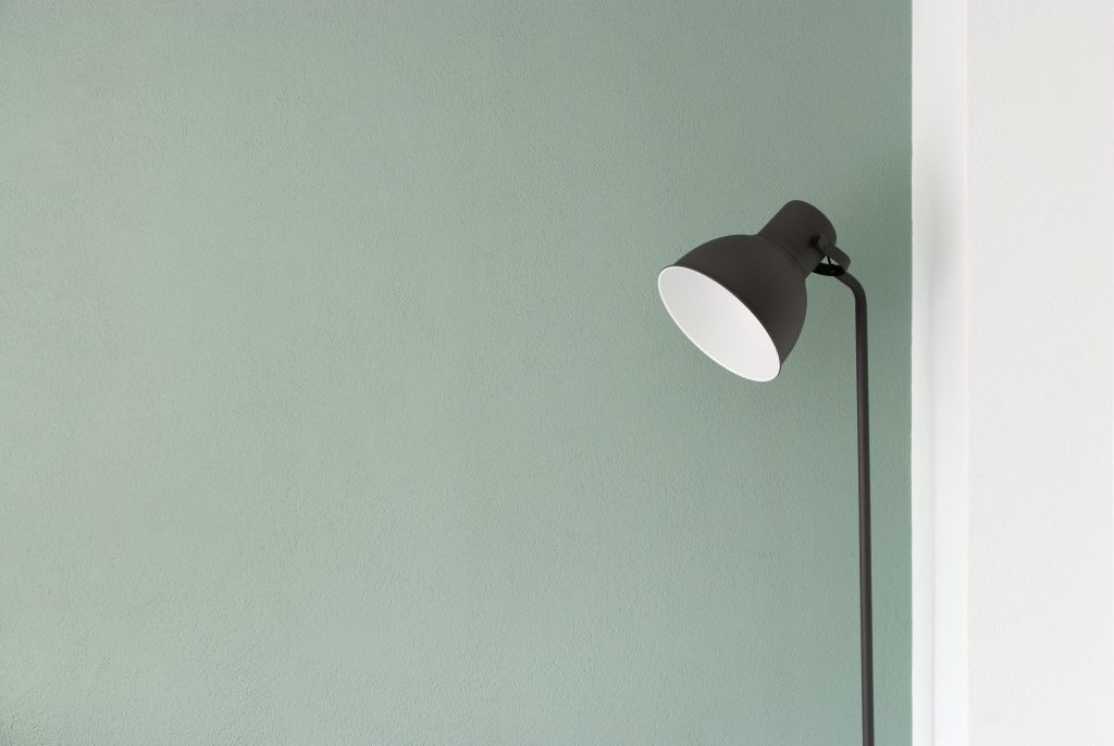 a white lamp next to wall